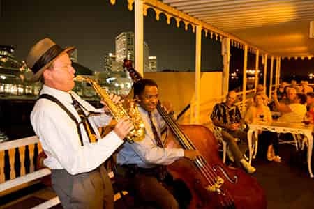Jazz musicians performing on the Creole Queen at night
